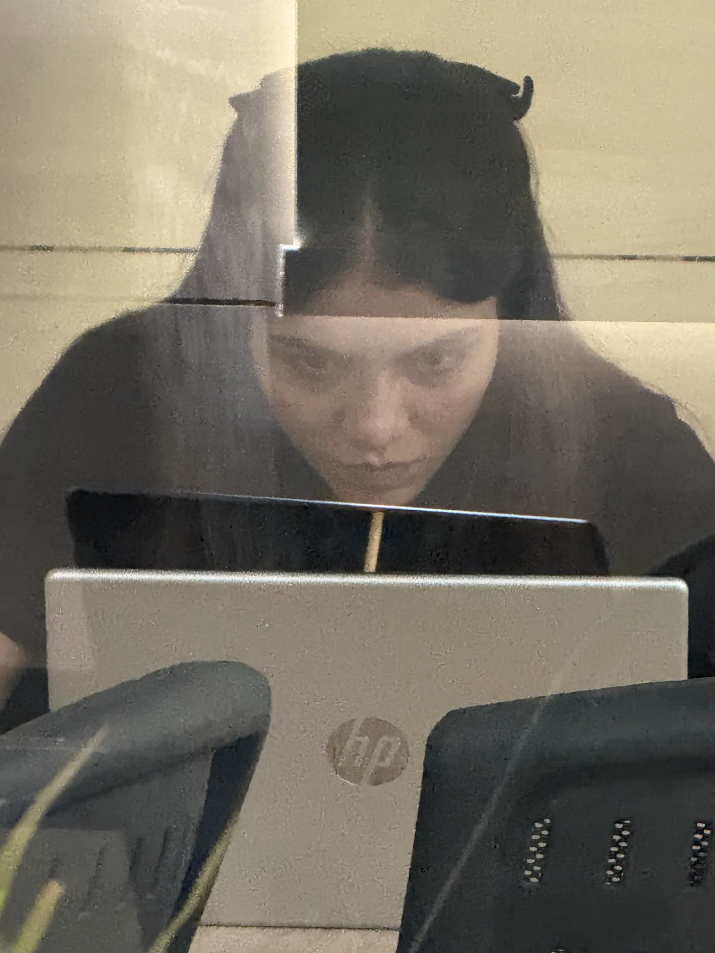 Aiko behind a monitor at the office