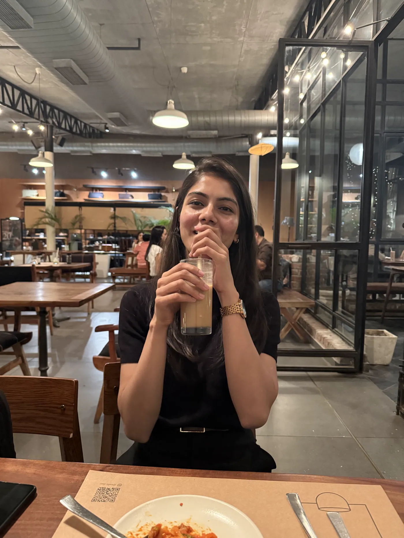 Aiko holding an iced drink with both hands