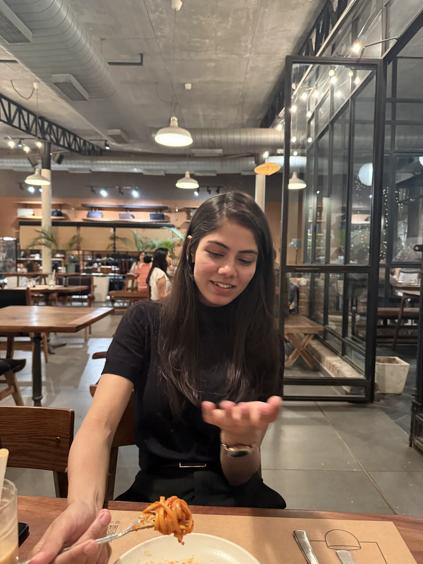 Aiko raising a hand mid-sentence